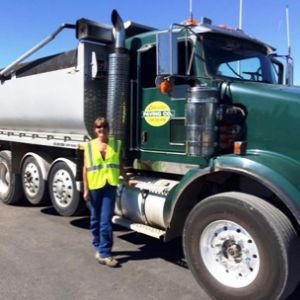 Jessie Taylor Standing Next To Her Lakeridge Paving Co. Dump She Drives After The Training She Completed With CSD Truck School.